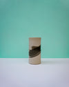 Cylindrical ceramic vase with black abstract design on a light green background. Janne Meijer Ceramics | Shop Fodder