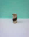 Ceramic vase with black band on a white surface and green background. Janne Meijer Ceramics | Shop Fodder