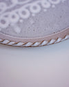 Close up of trailed cream slip pattern and pie crust rim