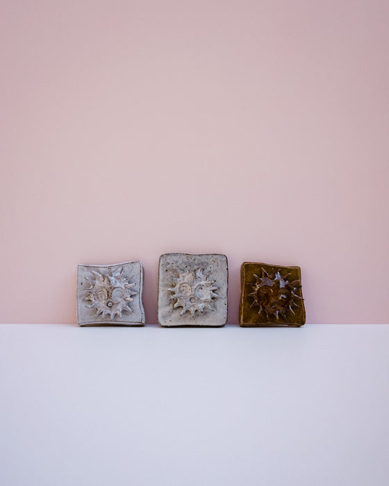 Sun wall tile by Lily Pearmain - 3D sun motif - tin white glaze - handmade stoneware - Fodder