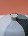 Ceramic vase with a textured surface on a peach background. Liz Vidal Ceramics | Shop Fodder