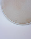 Close-up of a ceramic plate with a logo on a white background. Liz Vidal Ceramics | Shop Fodder