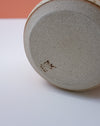 Close-up of a ceramic plate with a textured surface on a white background. Liz Vidal Ceramics | Shop Fodder