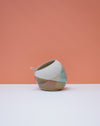 Ceramic pot with geometric design on a peach and white background. Liz Vidal Ceramics | Shop Fodder