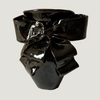 Black bow-shaped object on a light gray background. Amelia Christoffers | Shop Fodder