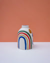 Vase with colorful rainbow design on a peach background. Sophie Alda | Handmade Ceramics | Shop Fodder