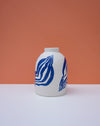 White vase with blue abstract patterns on a peach background. Sophie Alda | Handmade Ceramics | Shop Fodder