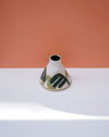Cylindrical ceramic vase with abstract design on a white surface and peach background. Sophie Alda | Handmade Ceramics | Shop Fodder