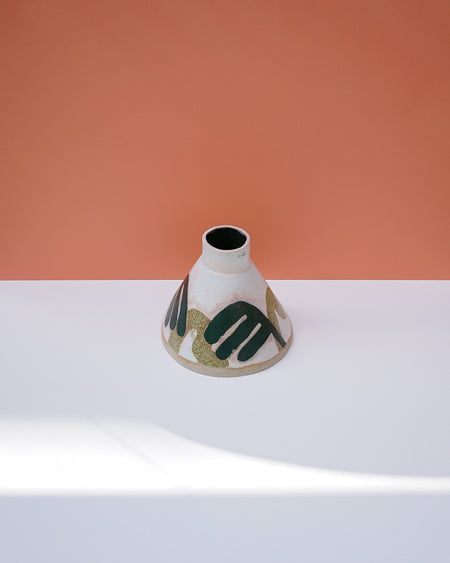 Cylindrical ceramic vase with abstract design on a white surface and peach background. Sophie Alda | Handmade Ceramics | Shop Fodder