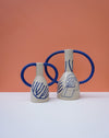 Two ceramic vases with blue handles and abstract designs on a peach background. Sophie Alda | Handmade Ceramics | Shop Fodder