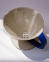 Ceramic coffee filter with blue handle on a white background. Sophie Alda | Handmade Ceramics | Shop Fodder