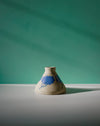 Ceramic vase with blue floral design on a green and gray background. Sophie Alda | Handmade Ceramics | Shop Fodder