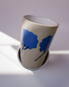 Ceramic cup with blue floral design on a light background. Sophie Alda | Handmade Ceramics | Shop Fodder