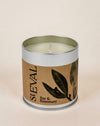 A St Eval Bay & Rosemary scented candle in a silver metal tin with a brown kraft paper label featuring black leaf illustrations.