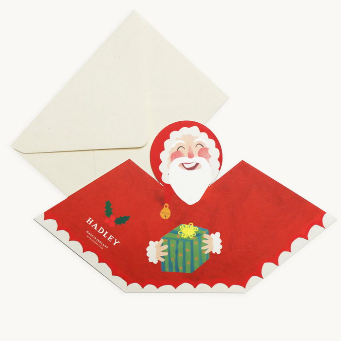 Christmas card with Santa Claus holding a gift, featuring the brand 'Hadley'. Hadley Paper Goods | Shop Fodder