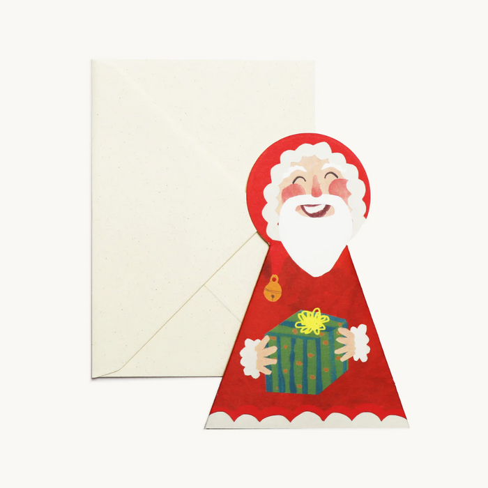 Card with a cartoon Santa Claus holding a gift, featuring a white envelope. Hadley Paper Goods | Shop Fodder
