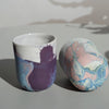 two planters on a table. one standing up and one on its side so you can see the base and the makers mark of JDP ceramics. 