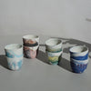 four pairs of marbled espresso cups on a table. 