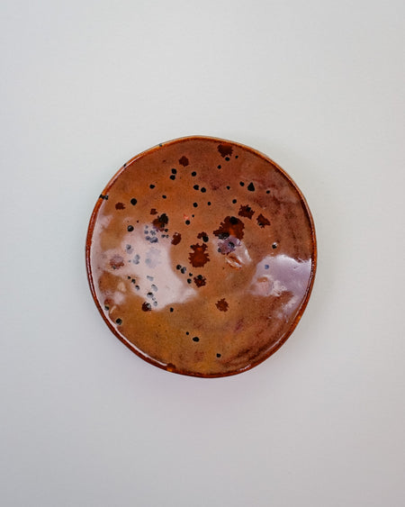 Round ceramic plate with brown speckled glaze on a white background. Diddy Bowl | Jode Pankhurst | Shop Fodder