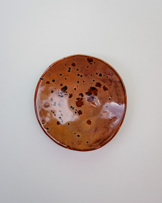 Round ceramic plate with brown speckled glaze on a white background. Diddy Bowl | Jode Pankhurst | Shop Fodder