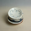 Stack of ceramic plates with blue decorative patterns on a neutral background. Diddy Bowl | Jode Pankhurst | Shop Fodder