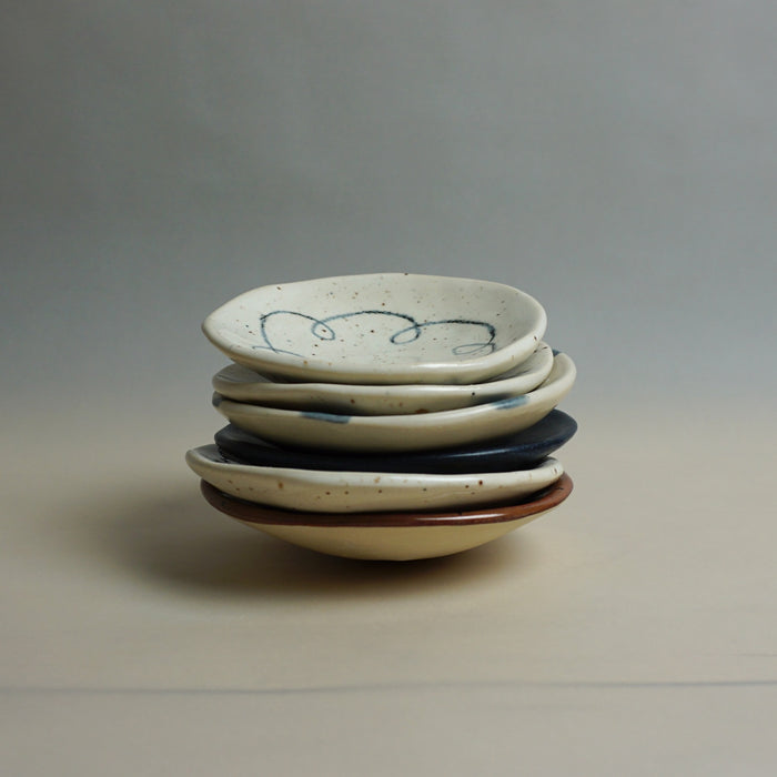 Stack of ceramic bowls with speckled patterns on a neutral background. Diddy Bowl | Jode Pankhurst | Shop Fodder