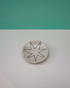 Round ceramic coaster with star design on a green and gray background. Diddy Bowl | Jode Pankhurst | Shop Fodder