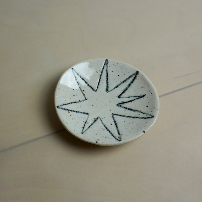 Ceramic plate with star design on a beige surface. Diddy Bowl | Jode Pankhurst | Shop Fodder