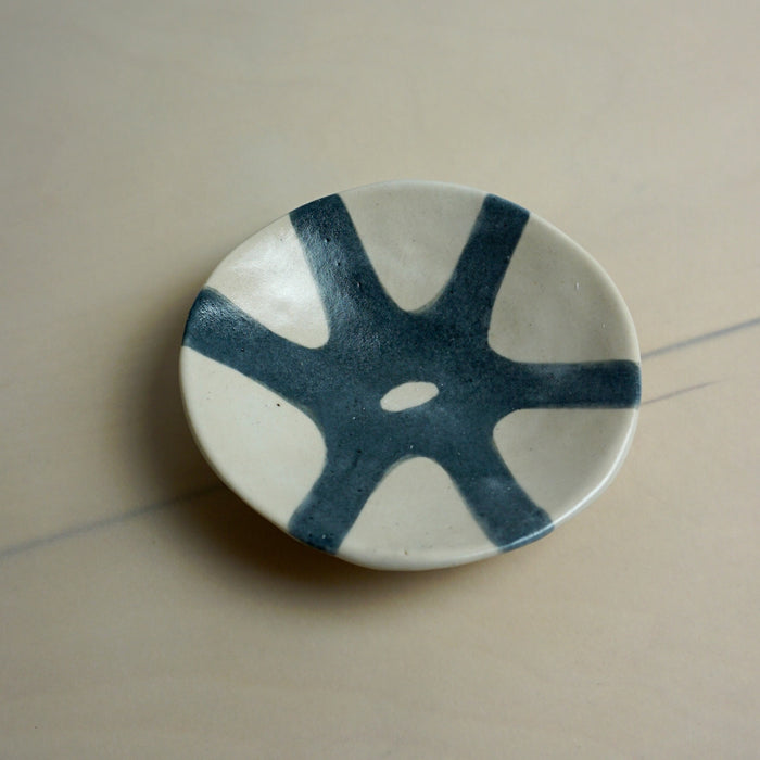 Ceramic dish with blue abstract design on a beige background. Diddy Bowl | Jode Pankhurst | Shop Fodder