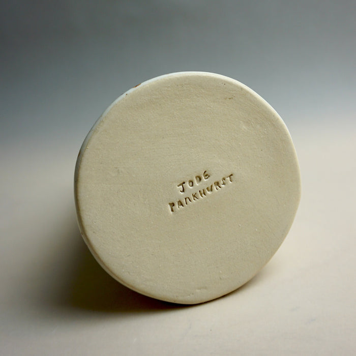 Round ceramic object with 'Jode Pankhurst' branding on a gray background. Fluted Ceramic Vase | Jode Pankhurst | Shop Fodder