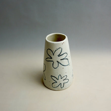 White ceramic vase with black floral patterns on a gray background. Fluted Ceramic Vase | Jode Pankhurst | Shop Fodder