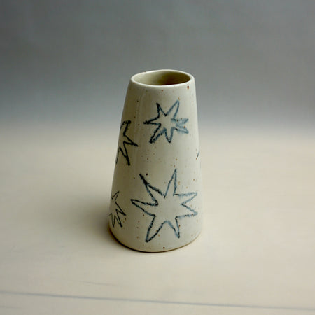 Cylindrical ceramic vase with star patterns on a plain background. Fluted Ceramic Vase | Jode Pankhurst | Shop Fodder