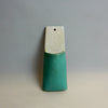 Ceramic pendant with a white top and green bottom on a gray background. Pocket Wall | Jode Pankhurst | Shop Fodder