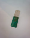 Rectangular object with green top and silver bottom on a light gray background | Jode Pankhurst