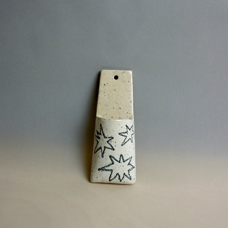 Ceramic pendant with star patterns on a grey background. Pocket Wall | Jode Pankhurst | Shop Fodder
