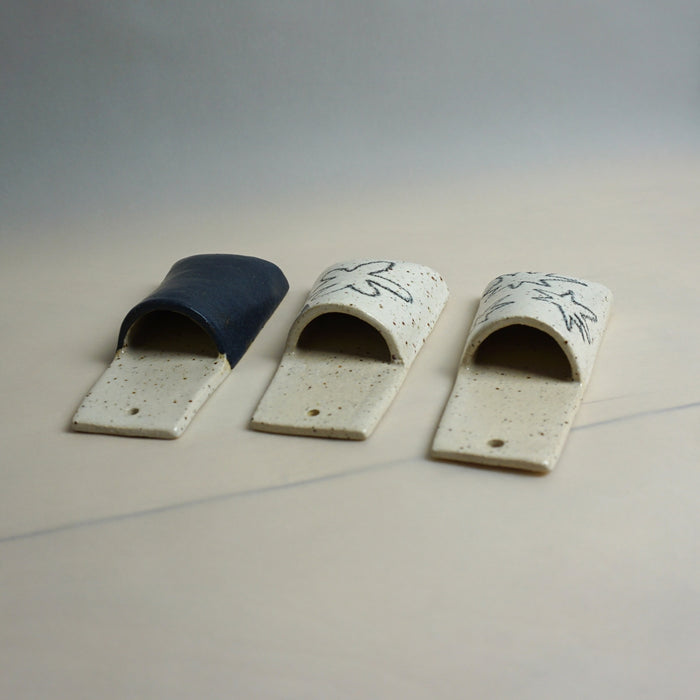 Three ceramic slideules with different designs on a neutral background. Pocket Wall | Jode Pankhurst | Shop Fodder