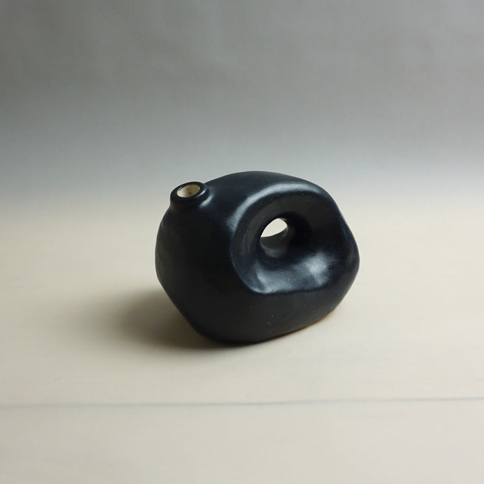 Black ceramic vase on a light gray background. Samara Collection | Jode Pankhurst | Shop Fodder