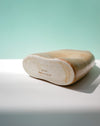 Wooden shoe last on a white surface with a light green background | Jode Pankhurst