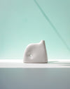 White ceramic sculpture on a light gray surface with a light blue gradient background | Jode Pankhurst