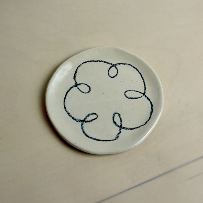 Round ceramic plate with black abstract design on a beige background. Trinket Dish | Jode Pankhurst | Shop Fodder