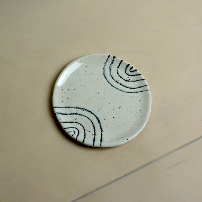 Round ceramic plate with black abstract patterns on a beige background. Trinket Dish | Jode Pankhurst | Shop Fodder