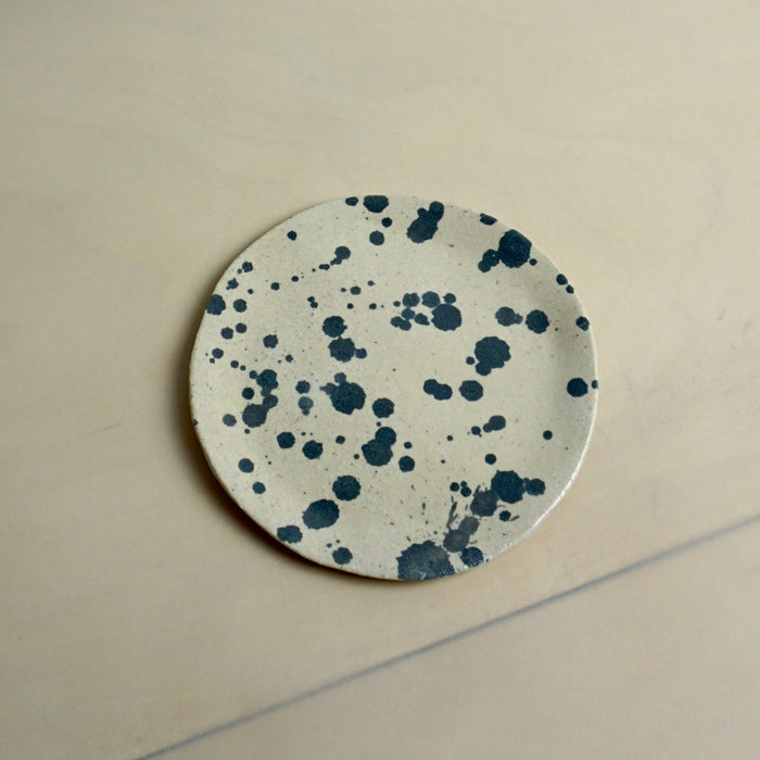 Round ceramic coaster with blue speckles on a beige background. Trinket Dish | Jode Pankhurst | Shop Fodder