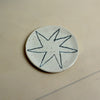 Ceramic disc with star design on a beige background. Trinket Dish | Jode Pankhurst | Shop Fodder