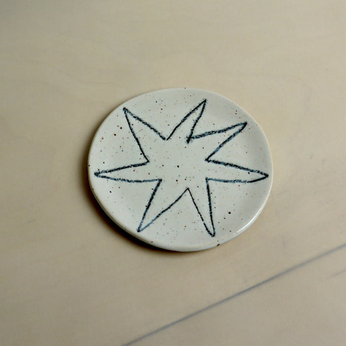 Ceramic disc with star design on a beige background. Trinket Dish | Jode Pankhurst | Shop Fodder