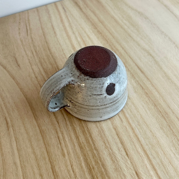 Small ceramic cup with brown interior on a light wooden surface. Lily Pearmain Ceramics | Shop Fodder