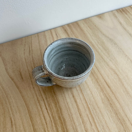 Small ceramic cup on a wooden surface. Lily Pearmain Ceramics | Shop Fodder