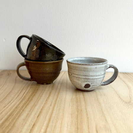 Three ceramic espresso cups on a wooden surface with a white background. Lily Pearmain Ceramics | Shop Fodder