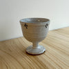 Ceramic goblet with speckled glaze on a wooden surface. Lily Pearmain Ceramics | Shop Fodder