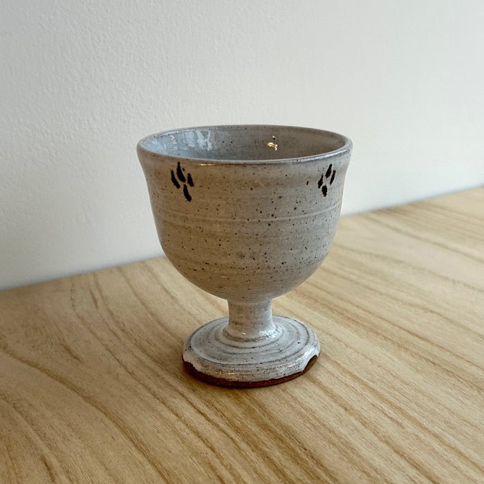 Ceramic goblet with speckled glaze on a wooden surface. Lily Pearmain Ceramics | Shop Fodder