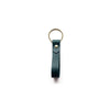 a green keyring with gold hardware on a white background. 